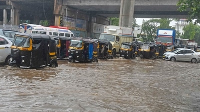 Commuters ply on a waterlogged Sahar road amid heavy rainfall, in Mumbai on Tuesday. (ANI Photo) Commuters ply on a waterlogged Sahar road amid heavy rainfall, in Mumbai on Tuesday. (ANI Photo)