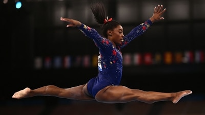 Simone Biles competes in the artistic gymnastics balance beam event of the women's qualification during the Tokyo 2020 Olympic Games (AFP)