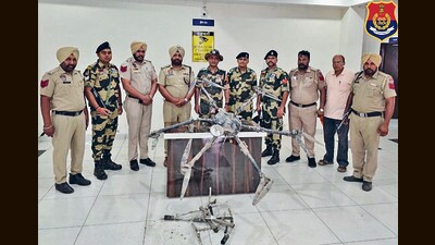 Police and BSF officials with the drone seized in Tarn Taran on Wednesday.