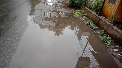 Rainwater is not drained fully due to uneven road surfaces. Manholes of stormwater drains are located higher than the road level at several locations and some are found at the top of sloping roads, says activist. (HT PHOTO) Rainwater is not drained fully due to uneven road surfaces. Manholes of stormwater drains are located higher than the road level at several locations and some are found at the top of sloping roads, says activist. (HT PHOTO)