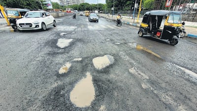 Road in front of Anna Bhau Sathe auditorium at Padmavati which was tarred a week ago, developed potholes. (Pratham Gokhale/HT Photo) Road in front of Anna Bhau Sathe auditorium at Padmavati which was tarred a week ago, developed potholes. (Pratham Gokhale/HT Photo)
