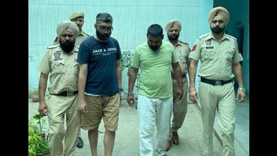 The financier and his aide in police custody on Wednesday. (HT Photo) The financier and his aide in police custody on Wednesday. (HT Photo)