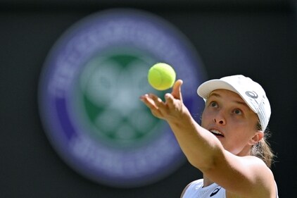 Poland's Iga Swiatek serves to France's Alize Cornet during their women's singles tennis match on the sixth day of the 2022 Wimbledon Championships (AFP) Poland's Iga Swiatek serves to France's Alize Cornet during their women's singles tennis match on the sixth day of the 2022 Wimbledon Championships (AFP)