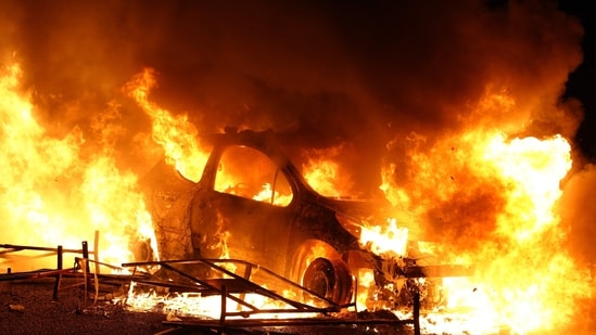 A vehicle burns, destroyed by protesters in Nanterre, west of Paris, on June 27, 2023, after French police killed a teenager who refused to stop for a traffic check in the city. (AFP)