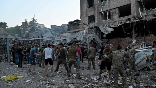 Rescuers and volunteers work to rescue people from under the rubble after a Russian missile strike hit a restaurant and several houses in Kramatorsk, eastern Ukraine, on June 27, 2023. (AFP)