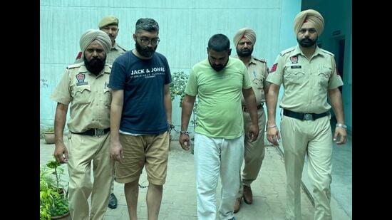 The financier and his aide in police custody on Wednesday. (HT Photo)