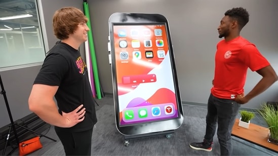 Marques Brownlee (MKBHD) reviewing the 8 feet tall fully-functional ‘iPhone’ created by YouTuber Matthew Beem and team. (YouTube/Matthew Beem)