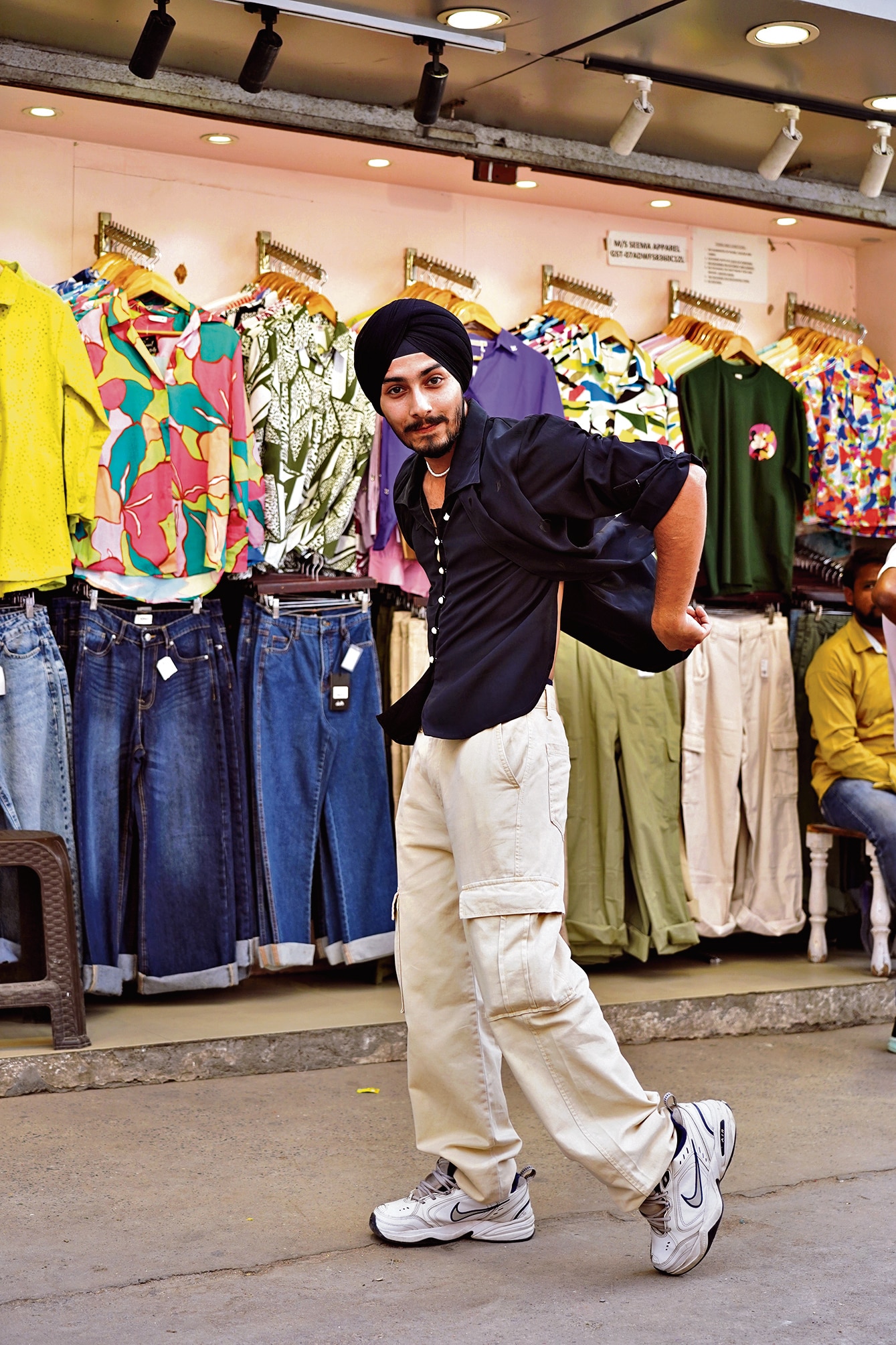 Sadeev Singh, a student of Sri Guru Gobind Singh College of Commerce, pairs his pearl jewellery with pear buttons on a black shirt from Kamla Nagar market. (Photo: Gokul VS/HT) Sadeev Singh, a student of Sri Guru Gobind Singh College of Commerce, pairs his pearl jewellery with pear buttons on a black shirt from Kamla Nagar market. (Photo: Gokul VS/HT)