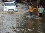 Commuters make their way through the waterlogged Delhi-Gurugram Expressway service road following heavy rains, Commuters make their way through the waterlogged Delhi-Gurugram Expressway service road following heavy rains,