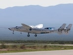 Virgin Galactic's passenger rocket plane VSS Unity, borne by twin-fuselage carrier jet dubbed VMS Eve. 