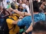 The men are seen throwing punches and pushing each other before some commuters intervene to pull them apart. (Twitter) The men are seen throwing punches and pushing each other before some commuters intervene to pull them apart. (Twitter)