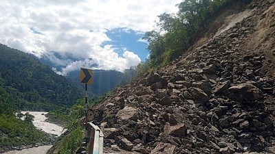 A pile of debris is seen after landslides blocked the road for passengers traveling to Badrinath and Hemkund, in Chamoli on Thursday. (ANI)
