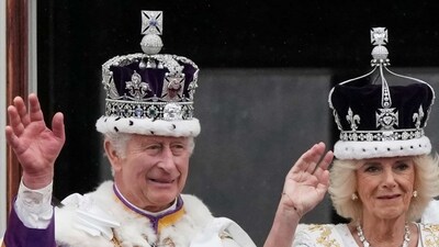 Britain's King Charles III and Queen Camilla wave to the crowds from the balcony of Buckingham Palace after the coronation ceremony in London. (AP)