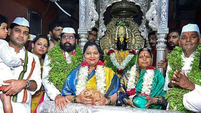 Maharashtra Chief Minister Eknath Shinde with his wife Lata Eknath Shinde and their son and Balasahebanchi Shiv Sena leader Shrikant Shinde offers prayers at Vitthal Rukimini temple on the occasion of Ashadi Ekadashi, in Pandharpur on Wednesday. Warkari couple Bhausaheb Kale and Mangal Kale are also seen. (ANI) Maharashtra Chief Minister Eknath Shinde with his wife Lata Eknath Shinde and their son and Balasahebanchi Shiv Sena leader Shrikant Shinde offers prayers at Vitthal Rukimini temple on the occasion of Ashadi Ekadashi, in Pandharpur on Wednesday. Warkari couple Bhausaheb Kale and Mangal Kale are also seen. (ANI)