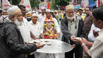 Muslim devotees offer snacks on the occasion of Eid-ul-Adha to the devotees of Vitthal during Wari procession on the occasion of Ashadhi Ekadashi at Wadala in Mumbai. (PTI) Muslim devotees offer snacks on the occasion of Eid-ul-Adha to the devotees of Vitthal during Wari procession on the occasion of Ashadhi Ekadashi at Wadala in Mumbai. (PTI)