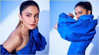 Rakul's stylish ensemble features exaggerated puffy sleeves with cinched hem, an off-shoulder detail on one side, a décolletage-flaunting neckline, a gathered design on the front and back, a figure-flaunting silhouette, and a mini hem length. (Instagram) Rakul's stylish ensemble features exaggerated puffy sleeves with cinched hem, an off-shoulder detail on one side, a décolletage-flaunting neckline, a gathered design on the front and back, a figure-flaunting silhouette, and a mini hem length. (Instagram)
