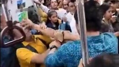 The men are seen throwing punches and pushing each other before some commuters intervene to pull them apart. (Twitter) The men are seen throwing punches and pushing each other before some commuters intervene to pull them apart. (Twitter)