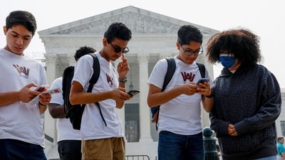 Students from Washington Adventist University look at their phones as news of the Supreme Court's decision pertaining to affirmative action is released outside the U.S. Supreme Court Building on June 29, 2023 in Washington, DC. (Getty Images via AFP) Students from Washington Adventist University look at their phones as news of the Supreme Court's decision pertaining to affirmative action is released outside the U.S. Supreme Court Building on June 29, 2023 in Washington, DC. (Getty Images via AFP)