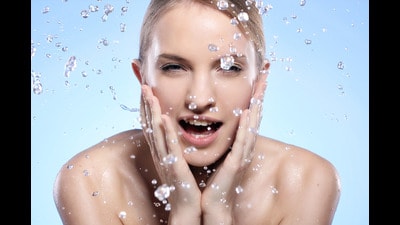 Young and beautiful woman washing her face Young and beautiful woman washing her face