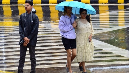 Mumbai, India – June 28, 2023: People going through the rain at the CST area, in Mumbai, India, on Wednesday, June 28, 2023. (Photo by Bhushan Koyande/HT Photo)(HT Photo/Bhushan Koyande)