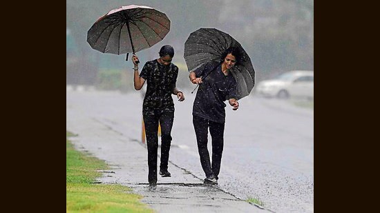 Youngsters enjoying the first rains of the season in Ludhiana. (HT PHOTO)