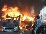 A photo shows cars burning in the street at the end of a commemoration march for a teenage driver shot dead by a policeman, in the Parisian suburb of Nanterre, on June 29, 2023. (AFP)