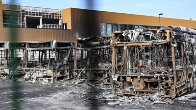 France Protests: Burnt buses seen through the gates at the Fort d'Aubervilliers bus terminal in Aubervilliers, north of Paris. (AFP) France Protests: Burnt buses seen through the gates at the Fort d'Aubervilliers bus terminal in Aubervilliers, north of Paris. (AFP)