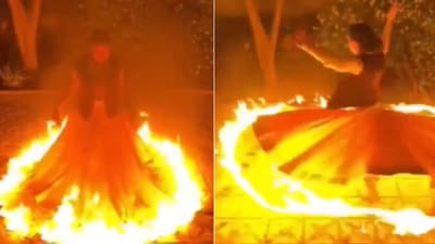 The image shows the woman twirling with a ring of fire around her dress. (Reddit/@fat_old_boy) The image shows the woman twirling with a ring of fire around her dress. (Reddit/@fat_old_boy)