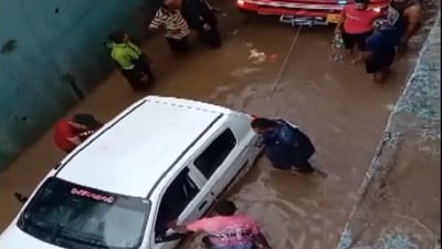 Car stuck in the Mandir Gam underpass in Gujarat is being pulled with the help of another vehicle. (ANI) Car stuck in the Mandir Gam underpass in Gujarat is being pulled with the help of another vehicle. (ANI)