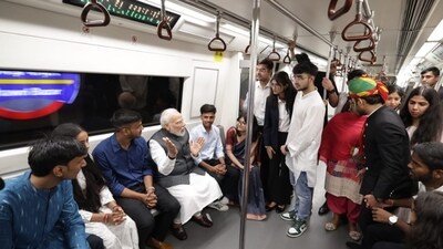 Prime Minister Narendra Modi engaging with fellow passengers during his metro ride to reach Delhi University, where he attended its centenary celebrations on Friday. Prime Minister Narendra Modi engaging with fellow passengers during his metro ride to reach Delhi University, where he attended its centenary celebrations on Friday.