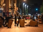 Protesters block a street with garbage cans in Colombes, outside Paris, France. 