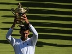 Novak Djokovic raises his trophy after defeating Nick Kyrgios during the men's singles final tennis match of the 2022 Wimbledon Championships Novak Djokovic raises his trophy after defeating Nick Kyrgios during the men's singles final tennis match of the 2022 Wimbledon Championships