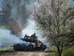 Ukrainian service members ride a tank, as Russia's attack on Ukraine continues, near the front line city of Bakhmut. 