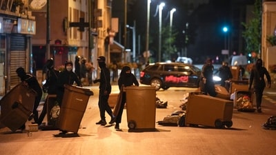 Protesters block a street with garbage cans in Colombes, outside Paris, France. (AP) Protesters block a street with garbage cans in Colombes, outside Paris, France. (AP)