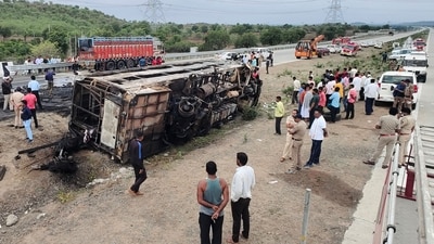 People gather around the wreckage of a bus that caught fire along the Samruddhi Expressway near Sindkhed Raja in Buldhana district of Maharashtra state on July 1, 2023. (AFP) People gather around the wreckage of a bus that caught fire along the Samruddhi Expressway near Sindkhed Raja in Buldhana district of Maharashtra state on July 1, 2023. (AFP)