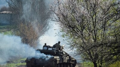 Ukrainian service members ride a tank, as Russia's attack on Ukraine continues, near the front line city of Bakhmut. (Reuters)