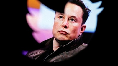 Elon Musk's photo is seen through a Twitter logo in this illustration. (Reuters)