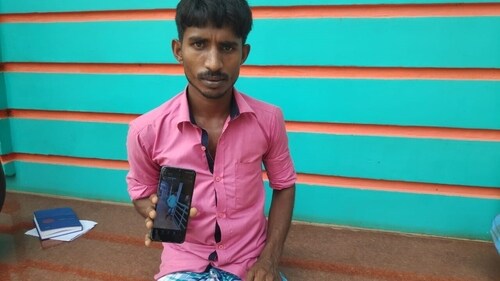 Sibcharan Rabidas showing the photo of his brother Krishna Rabidas. Sibcharan Rabidas showing the photo of his brother Krishna Rabidas.