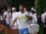 Novak Djokovic of Serbia, carries his bags as he walks to a practice session ahead of the Wimbledon tennis championships at Wimbledon, in London, Sunday, July 2, 2023. The Wimbledon Tennis championships start on July 3. (AP Photo/Kin Cheung) Novak Djokovic of Serbia, carries his bags as he walks to a practice session ahead of the Wimbledon tennis championships at Wimbledon, in London, Sunday, July 2, 2023. The Wimbledon Tennis championships start on July 3. (AP Photo/Kin Cheung)