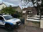 A municipal police officer stands in front of the damaged home of the mayor of l'Hay-les-Roses Vincent Jeanbrun, a suburb of Paris, on Sunday, after rioters rammed a vehicle into the building injuring his wife and one of his children,