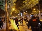 People run followed by police officers during riots following the death of Nahel, a 17-year-old teenager killed by a French police officer in Nanterre during a traffic stop, at Champs Elysees in Paris, France.