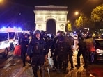French police officers patrol in front of the Arc de Triomphe in the Champs Elysees area of Paris on July 1, 2023, five days after a 17-year-old man was killed by police in Nanterre, a western suburb of Paris. 