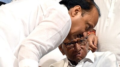 NCP president Sharad Pawar in a discussion with party leader Ajit Pawar after announcing being resigned from the party post at YB Chawan Auditorium in Mumbai in May. (ANI Photo) NCP president Sharad Pawar in a discussion with party leader Ajit Pawar after announcing being resigned from the party post at YB Chawan Auditorium in Mumbai in May. (ANI Photo)