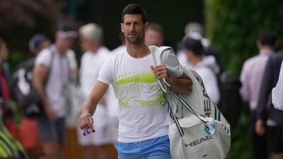 Novak Djokovic of Serbia, carries his bags as he walks to a practice session ahead of the Wimbledon tennis championships at Wimbledon, in London, Sunday, July 2, 2023. The Wimbledon Tennis championships start on July 3. (AP Photo/Kin Cheung) (AP) Novak Djokovic of Serbia, carries his bags as he walks to a practice session ahead of the Wimbledon tennis championships at Wimbledon, in London, Sunday, July 2, 2023. The Wimbledon Tennis championships start on July 3. (AP Photo/Kin Cheung) (AP)