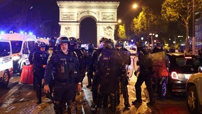 French police officers patrol in front of the Arc de Triomphe in the Champs Elysees area of Paris on July 1, 2023, five days after a 17-year-old man was killed by police in Nanterre, a western suburb of Paris. (AFP) French police officers patrol in front of the Arc de Triomphe in the Champs Elysees area of Paris on July 1, 2023, five days after a 17-year-old man was killed by police in Nanterre, a western suburb of Paris. (AFP)