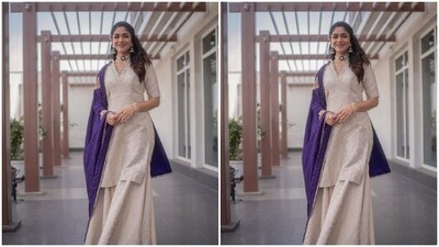 Mrunal looked stunning as ever in a silver kurta with a V-neckline and long sleeves. She teamed it with a set of matching frilled sharara. The actor added the necessary pop of colours to her look with a bright blue dupatta dotted with golden embellishments and golden resham thread work.&nbsp; (Instagram/@mrunalthakur)