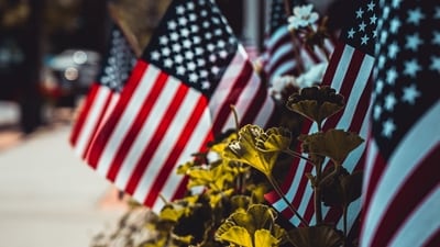 Patriotic Decorations: Many individuals decorate their homes and yards with patriotic-themed decorations such as banners, balloons, streamers, and wreaths. The colours red, white, and blue are prominently featured.&nbsp; (Unsplash)