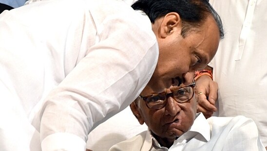 NCP president Sharad Pawar in a discussion with party leader Ajit Pawar after announcing being resigned from the party post at YB Chawan Auditorium in Mumbai in May. (ANI Photo)