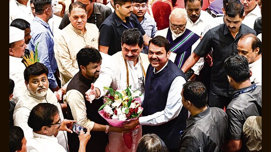 Maharashtra deputy chief minister Devendra Fadnavis with NCP leaders at Raj Bhavan in Mumbai. (Anshuman Poyrekar/HT)