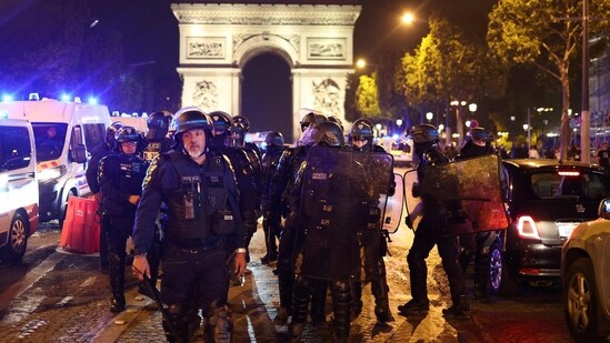 French police officers patrol in front of the Arc de Triomphe in the Champs Elysees area of Paris on July 1, 2023, five days after a 17-year-old man was killed by police in Nanterre, a western suburb of Paris. (AFP)